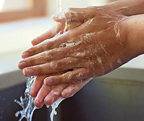 washing hands at kitchen sink