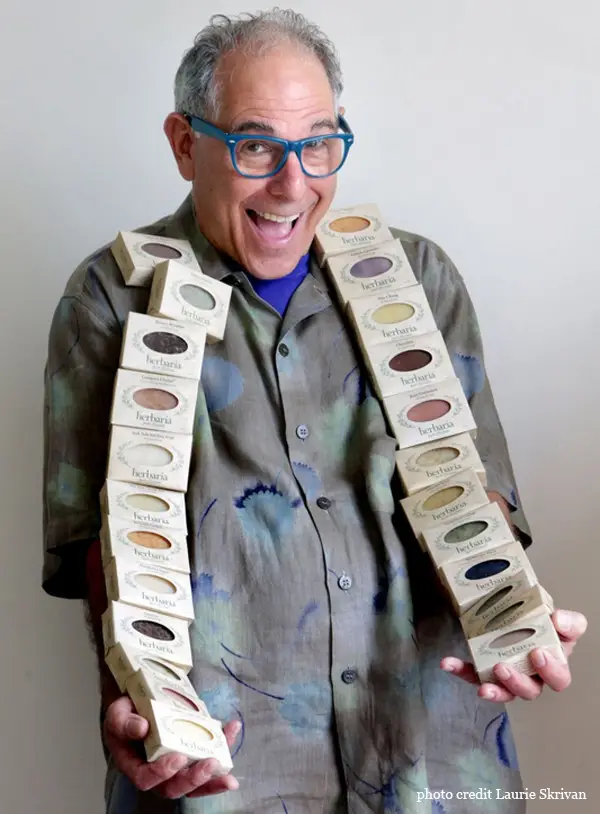 Founder, Ken Gilberg, holding stacks of soaps