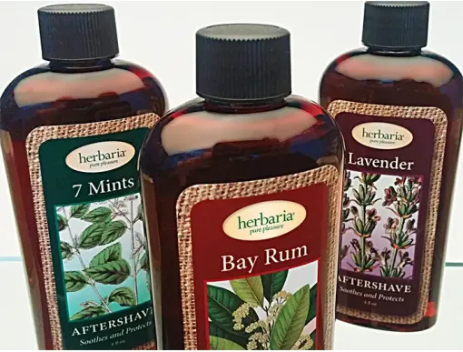 Herbaria all-natural aftershave bottles in Bay Rum, 7 Mints, and Lavender scents featuring essential oils and plant-based ingredients.