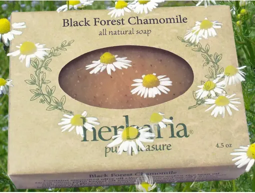 Black Forest Chamomile Herbaria soap bar with floating Chamomile blossoms dotting the image.