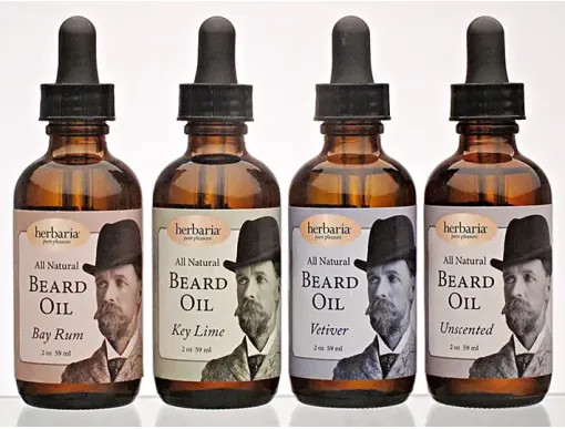 Herbaria handmade natural beard oil collection featuring four amber dropper bottles of unique essential oil scents.
