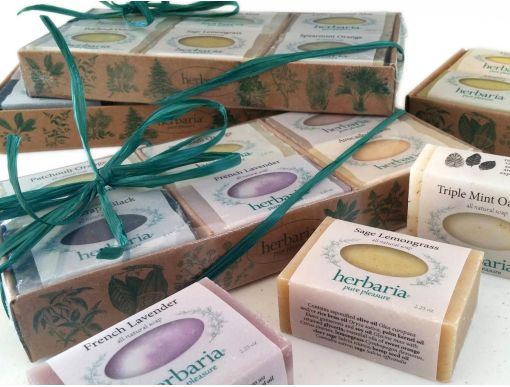 An array of 6 half bar herbaria soaps in a decorative tray.