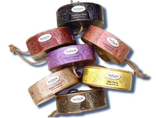A group of Herbaria Luffa soaps on their side to show their labels.