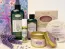 Herbaria natural lavender gift set featuring handmade soap, candle, bath bomb, almond oil, room spray, and headache oil in a floral wrapping paper.