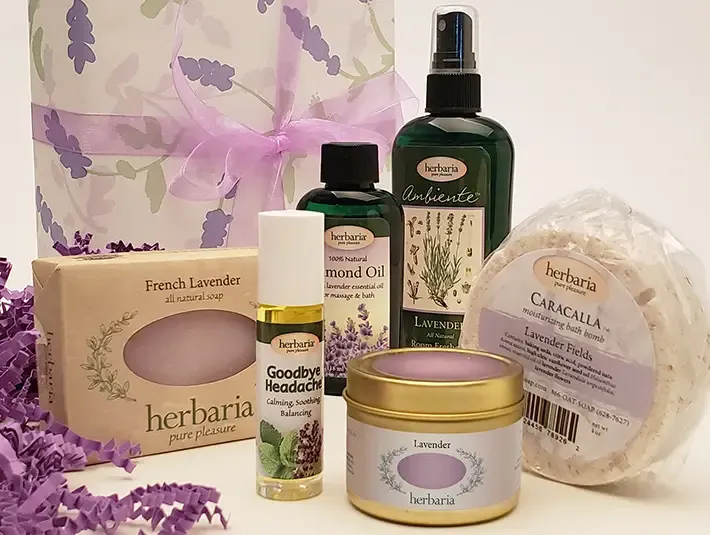 Herbaria Lavender Gift Set with 6 all-natural lavender bath products in a purple floral paper-wrapped box.