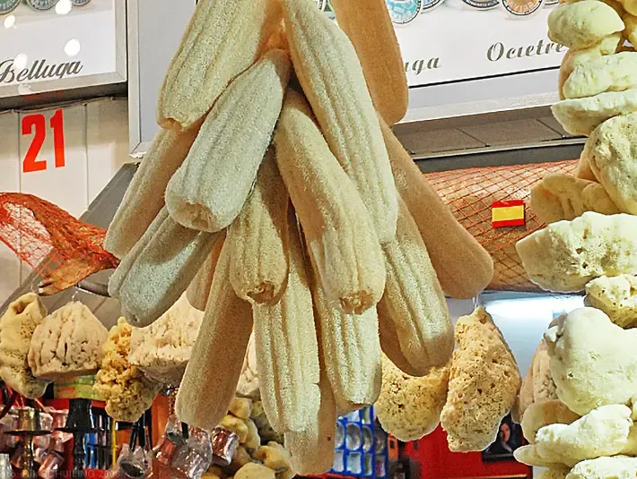 A hanging display of many loofahs in a turkish market.